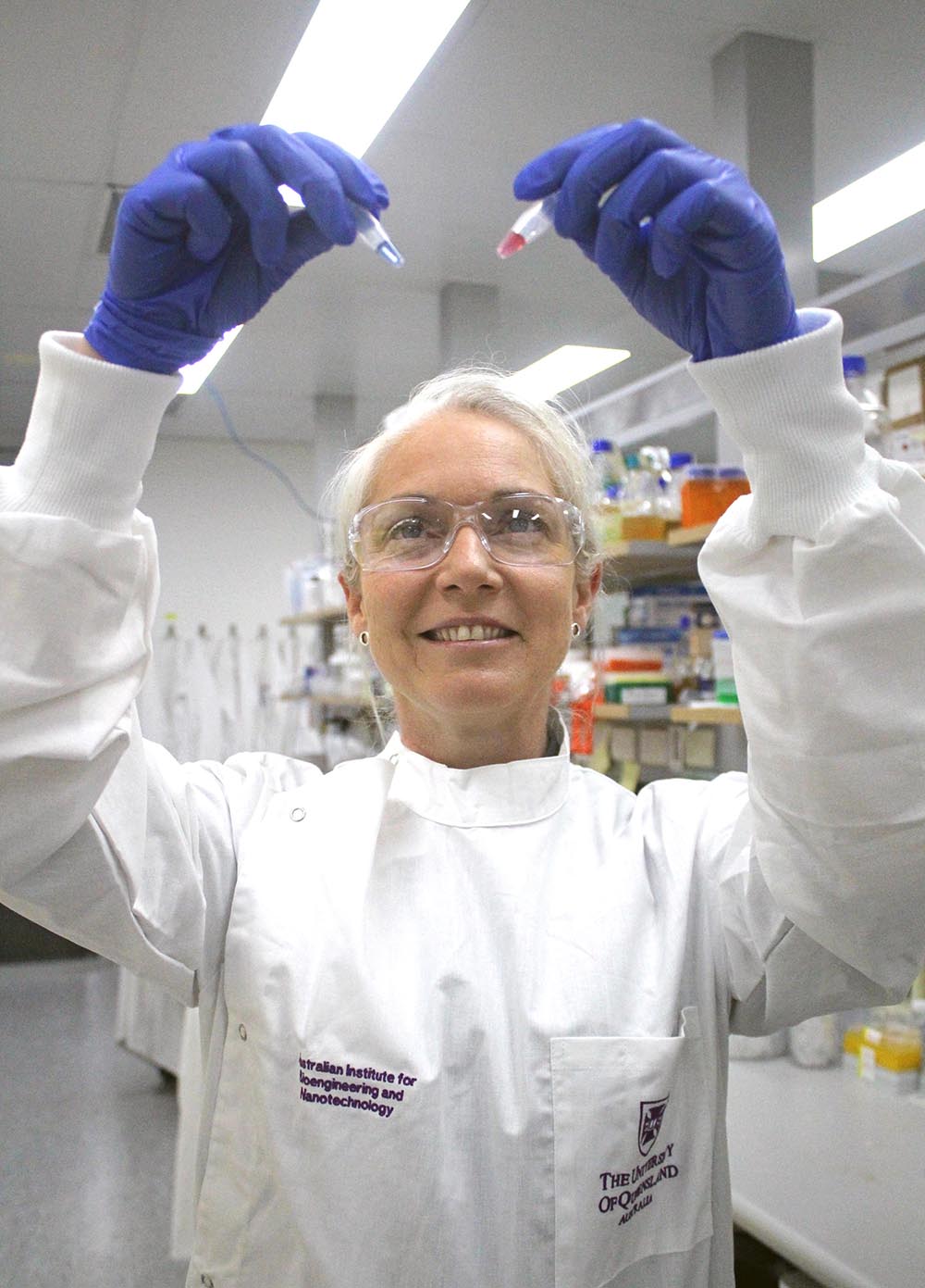 Anika McManus, holds up samples of the gold nanoparticles, which can change colour in the presence of DNA from cancer cells.