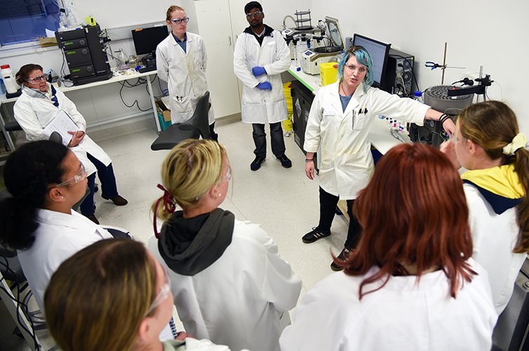 Students from Kingaroy State High School receive instruction on testing their materials in the lab